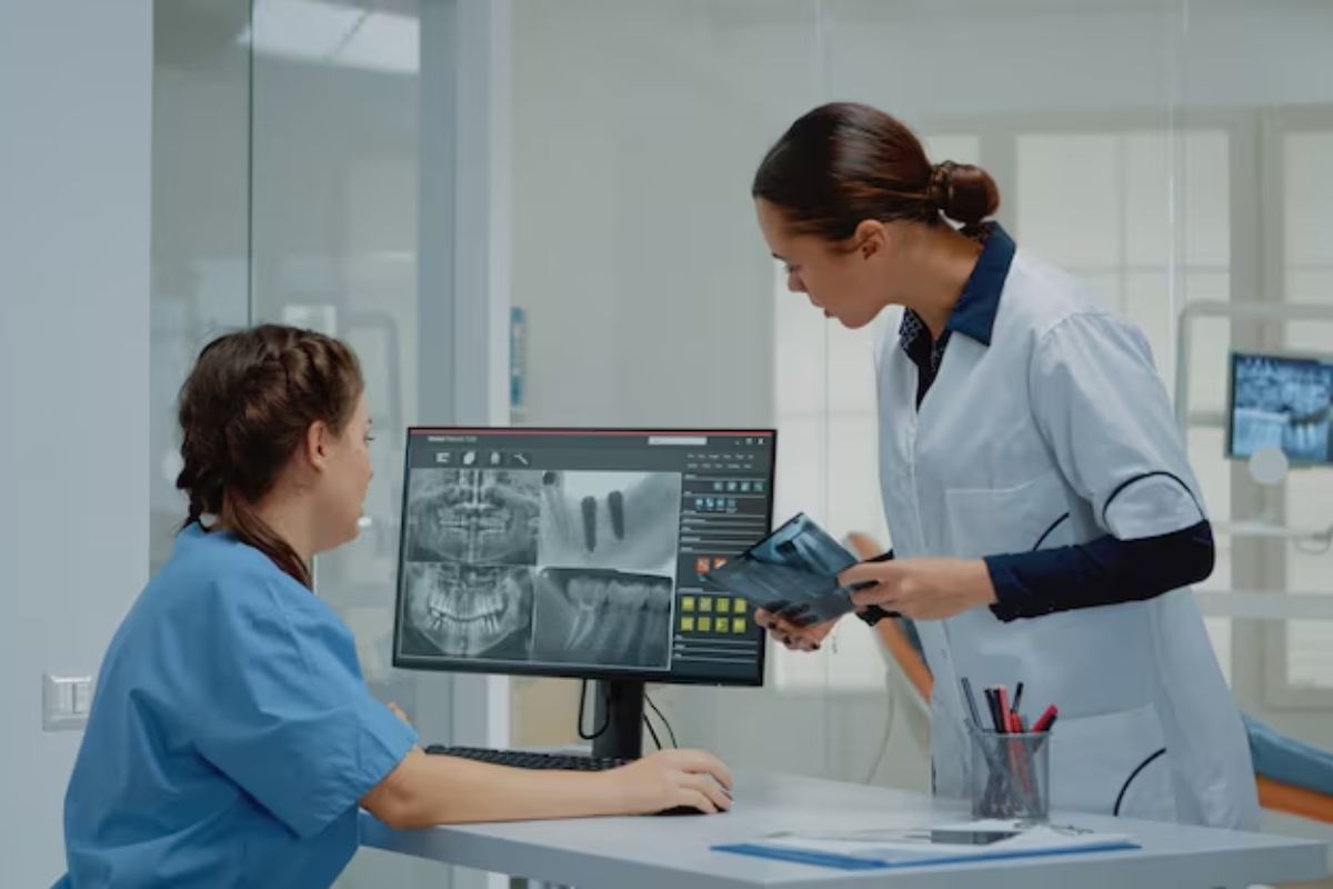 dentist reviewing dental x-rays and explaining treatment options during a patient consultation